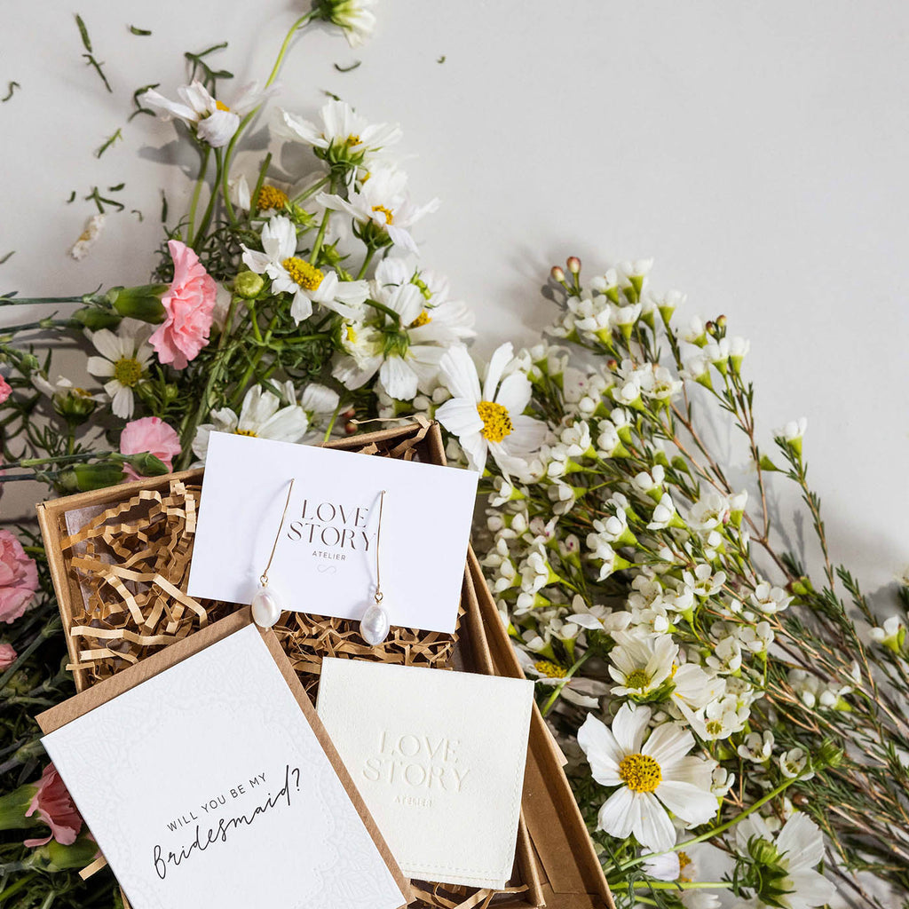 bridesmaid proposal box surrounded by fresh flowers